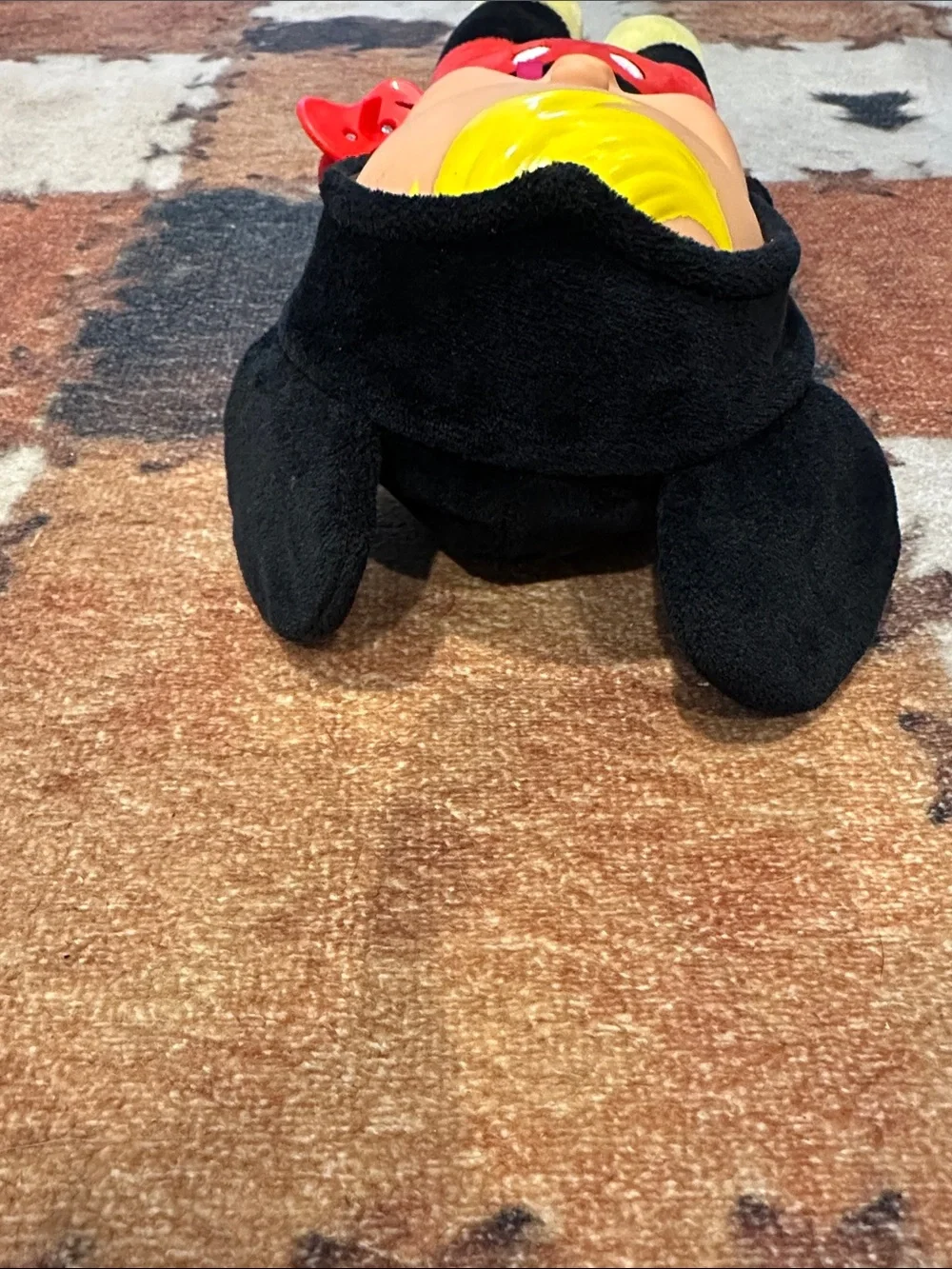 Plush Baby Doll in Black, Red & Yellow with Pink Bow